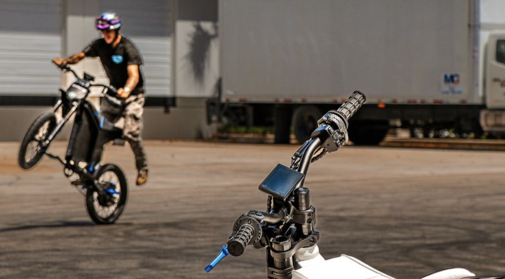 Three Sicario electric bikes lined up in a warehouse